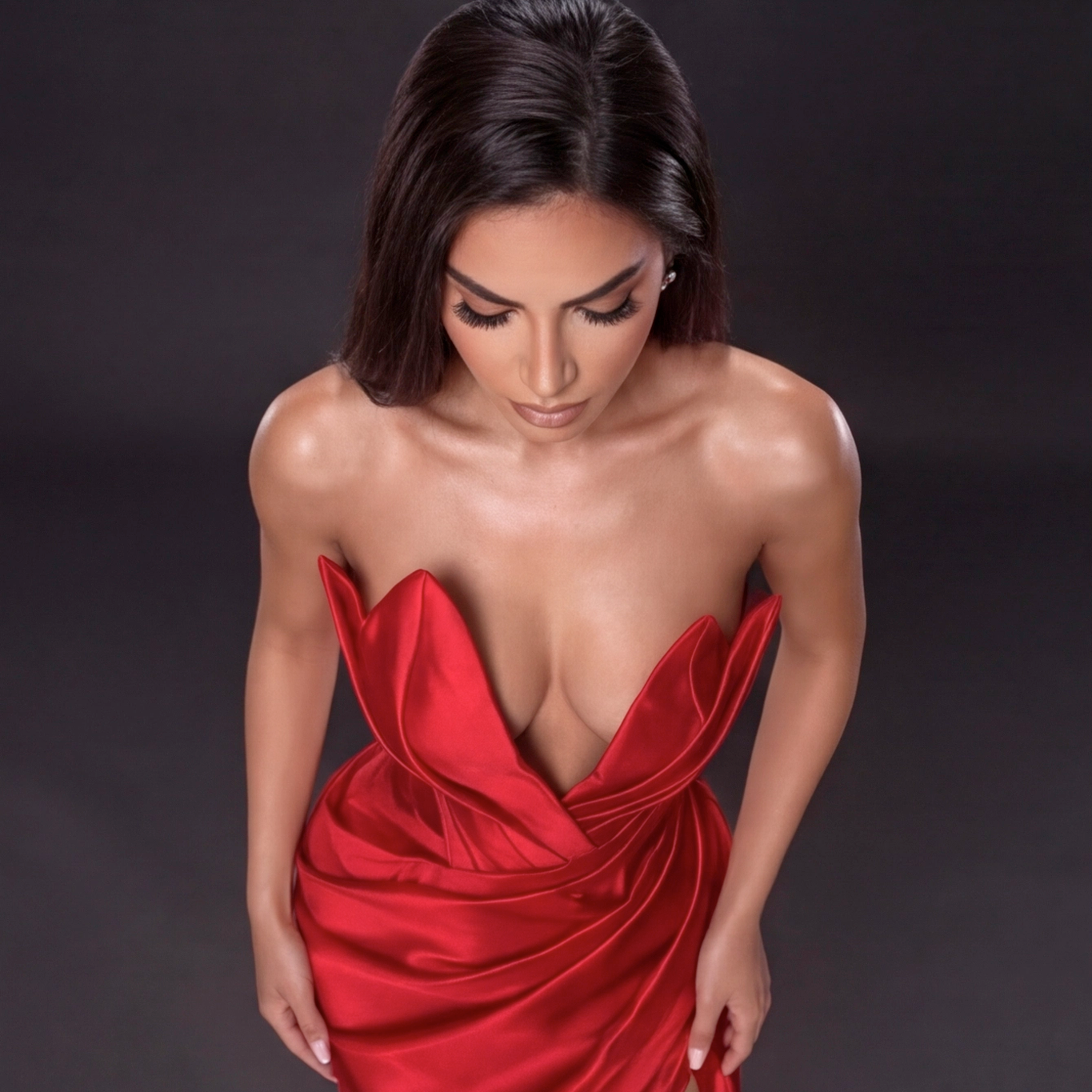 Red Satin Strapless Gown with Sculpted Deep V Neckline, Draped Waist, High Slit and Elegant Column Silhouette