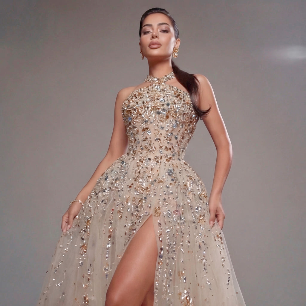 Woman wearing a sparkling evening gown against a neutral background