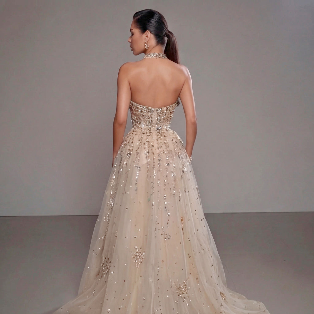 Woman wearing a sparkling evening gown with a plain background
