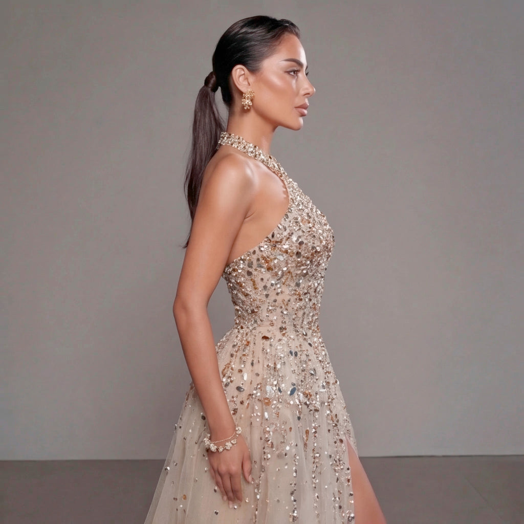 Woman wearing a sparkling evening gown against a neutral background