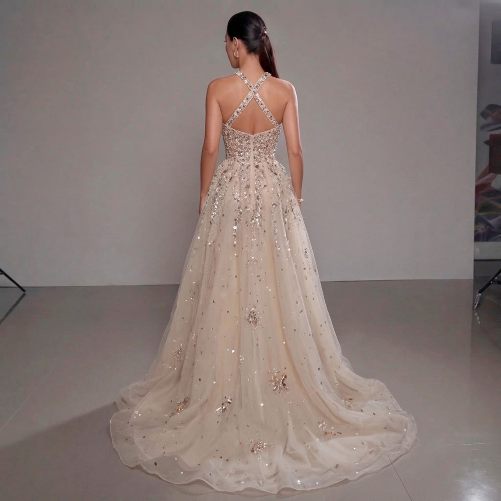 Woman wearing a sparkling evening gown with a plain background