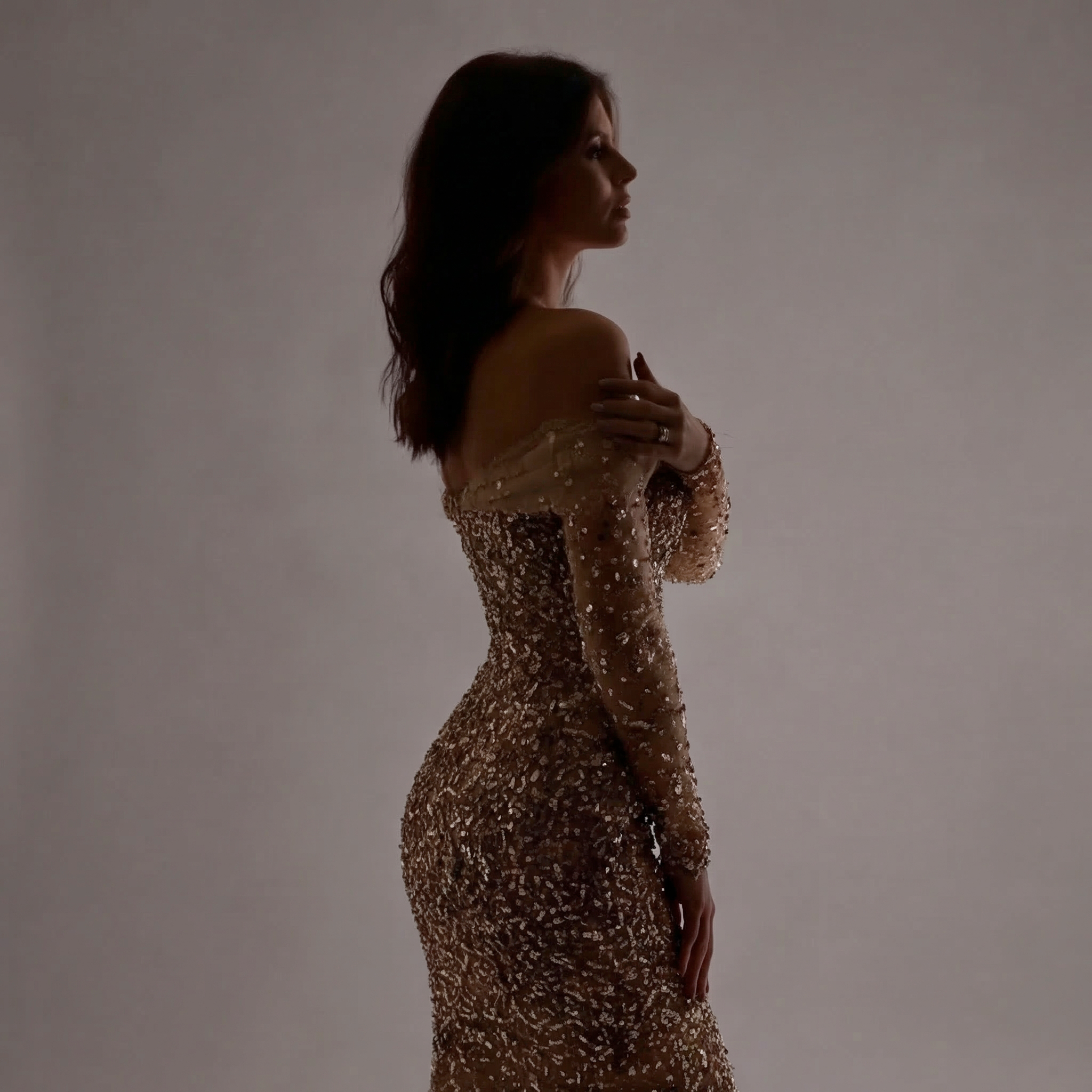 Nude Gold Off-Shoulder Mermaid Gown with Sheer Corset Bodice, Long Illusion Sleeves, Crystal Embellishments and High Slit Train