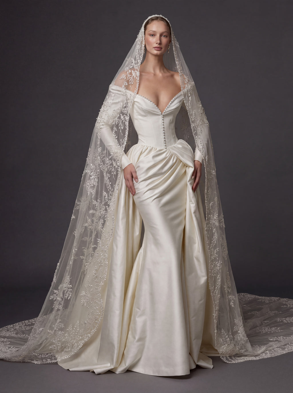 Pearl White Satin Corset Wedding Gown – Plunging Sweetheart Neckline, Draped Overskirt, Long Sleeves & Embroidered Cathedral Veil