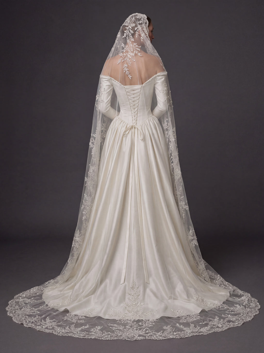 Pearl White Satin Corset Wedding Gown – Plunging Sweetheart Neckline, Draped Overskirt, Long Sleeves & Embroidered Cathedral Veil