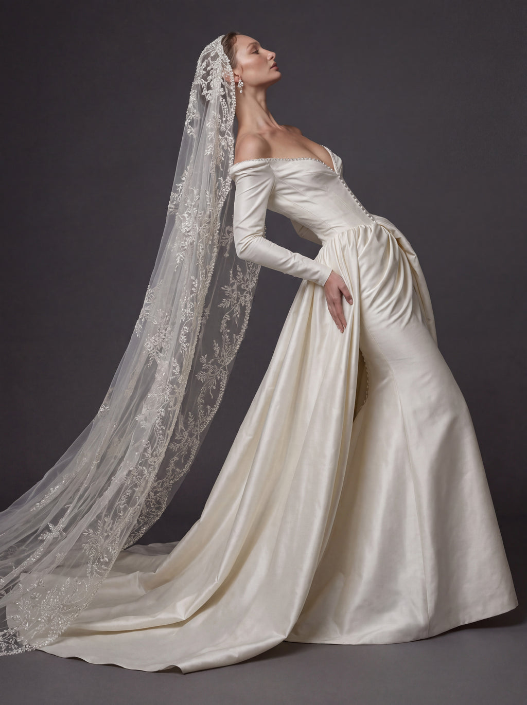 Pearl White Satin Corset Wedding Gown – Plunging Sweetheart Neckline, Draped Overskirt, Long Sleeves & Embroidered Cathedral Veil