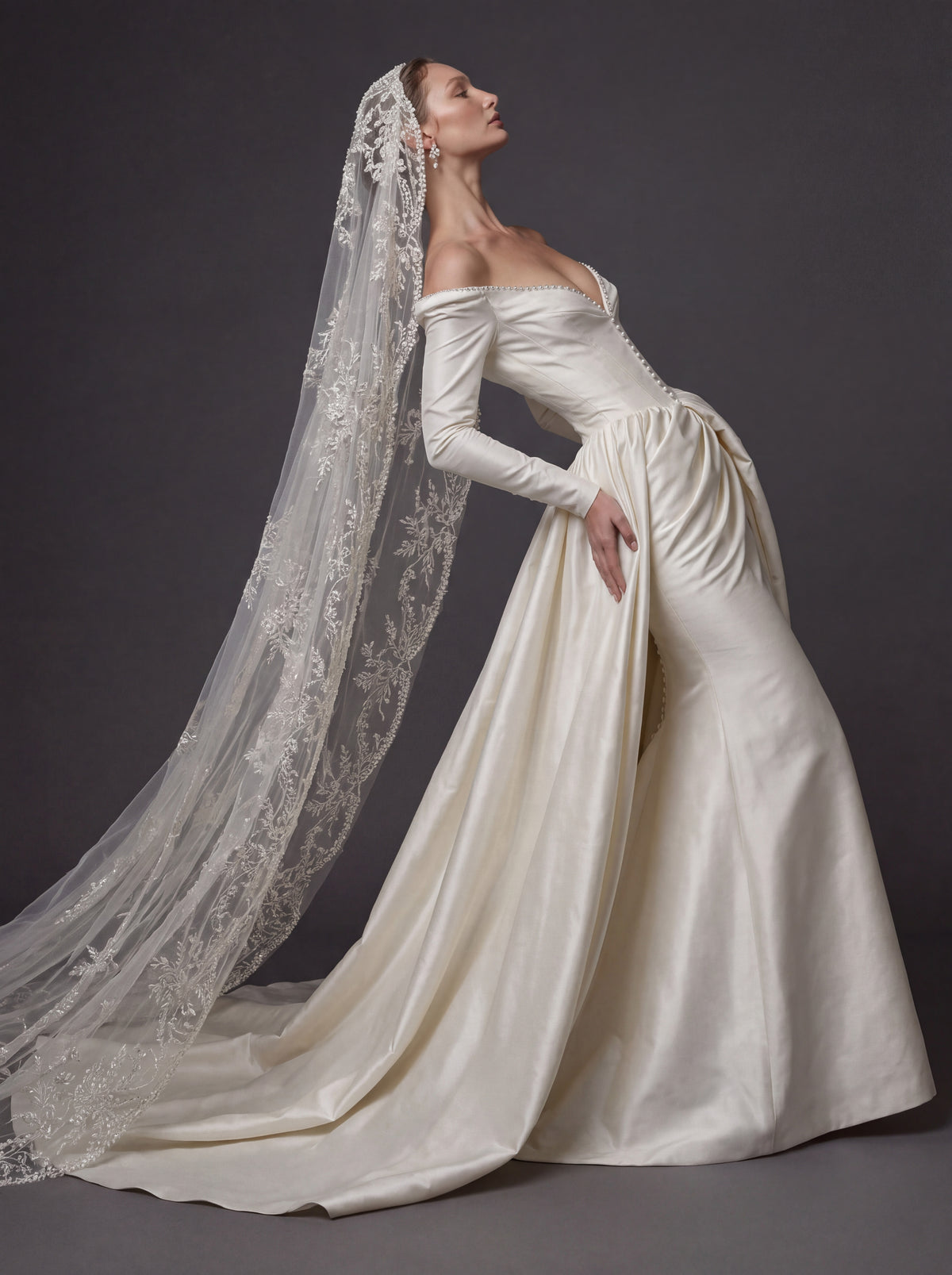 Pearl White Satin Corset Wedding Gown – Plunging Sweetheart Neckline, Draped Overskirt, Long Sleeves & Embroidered Cathedral Veil
