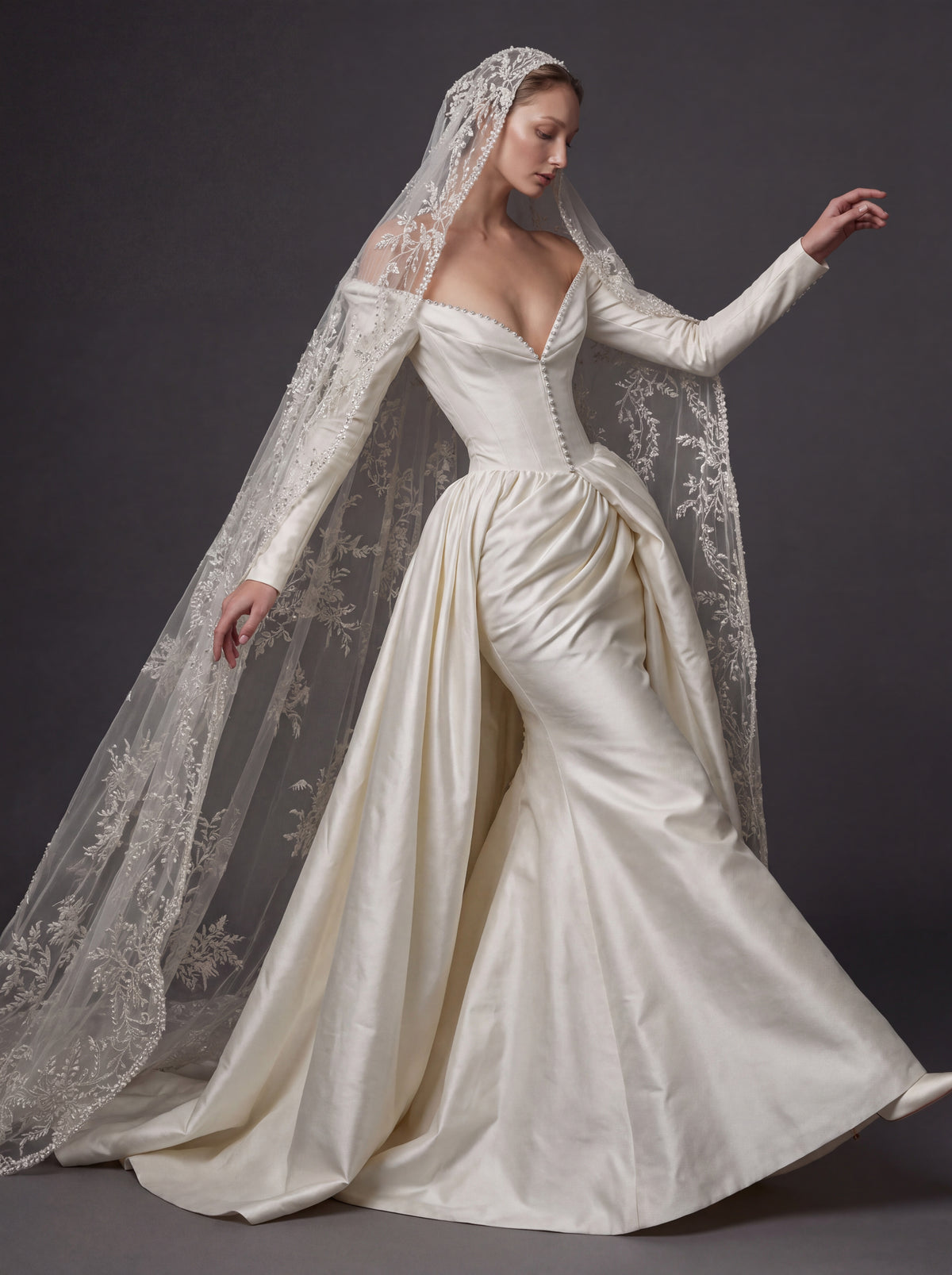 Pearl White Satin Corset Wedding Gown – Plunging Sweetheart Neckline, Draped Overskirt, Long Sleeves & Embroidered Cathedral Veil