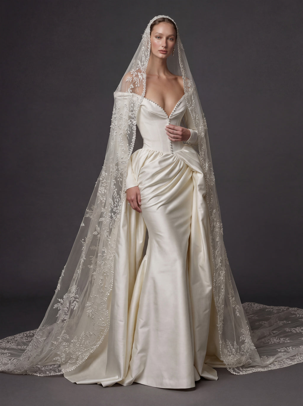 Pearl White Satin Corset Wedding Gown – Plunging Sweetheart Neckline, Draped Overskirt, Long Sleeves & Embroidered Cathedral Veil
