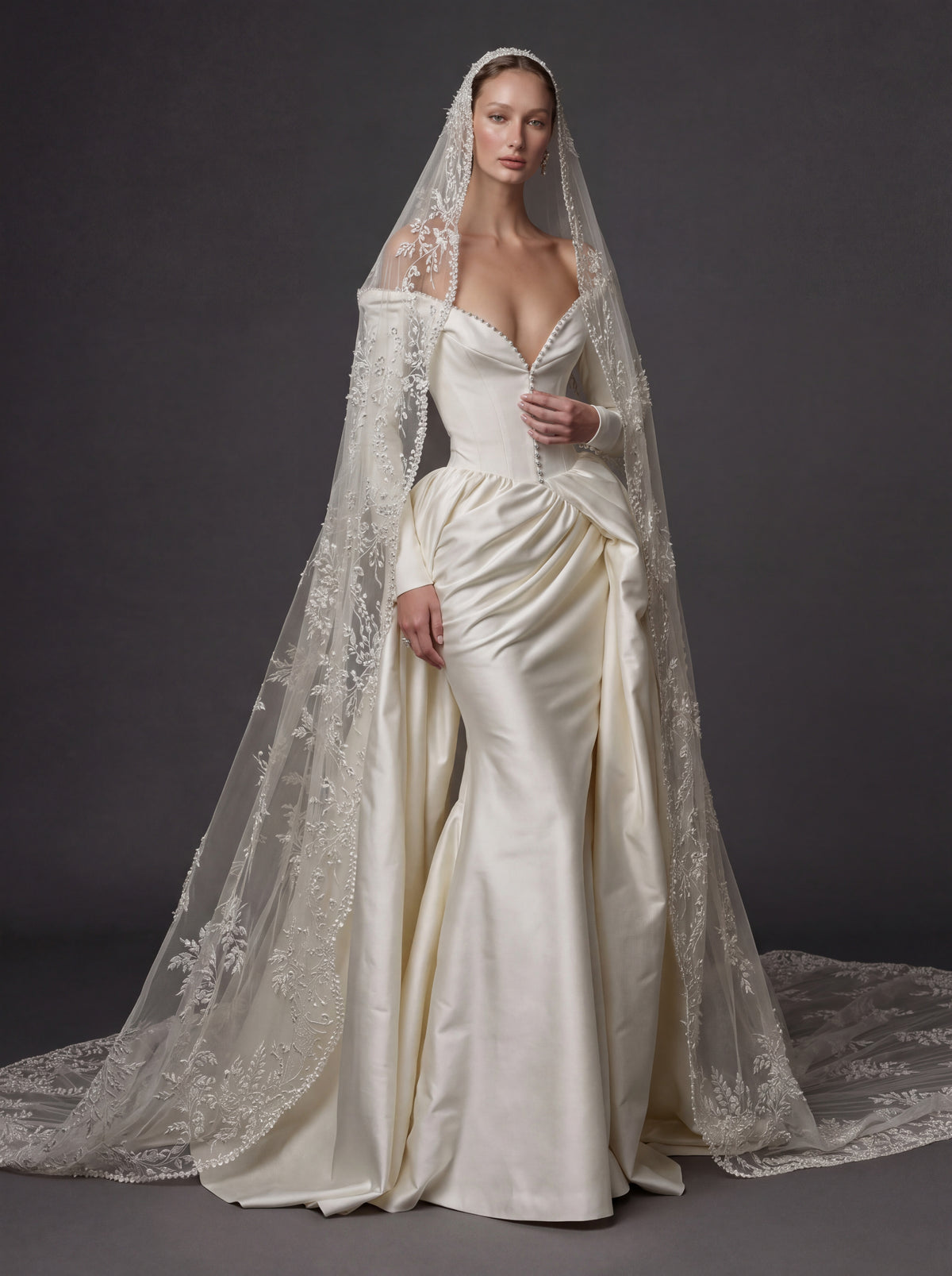 Pearl White Satin Corset Wedding Gown – Plunging Sweetheart Neckline, Draped Overskirt, Long Sleeves & Embroidered Cathedral Veil