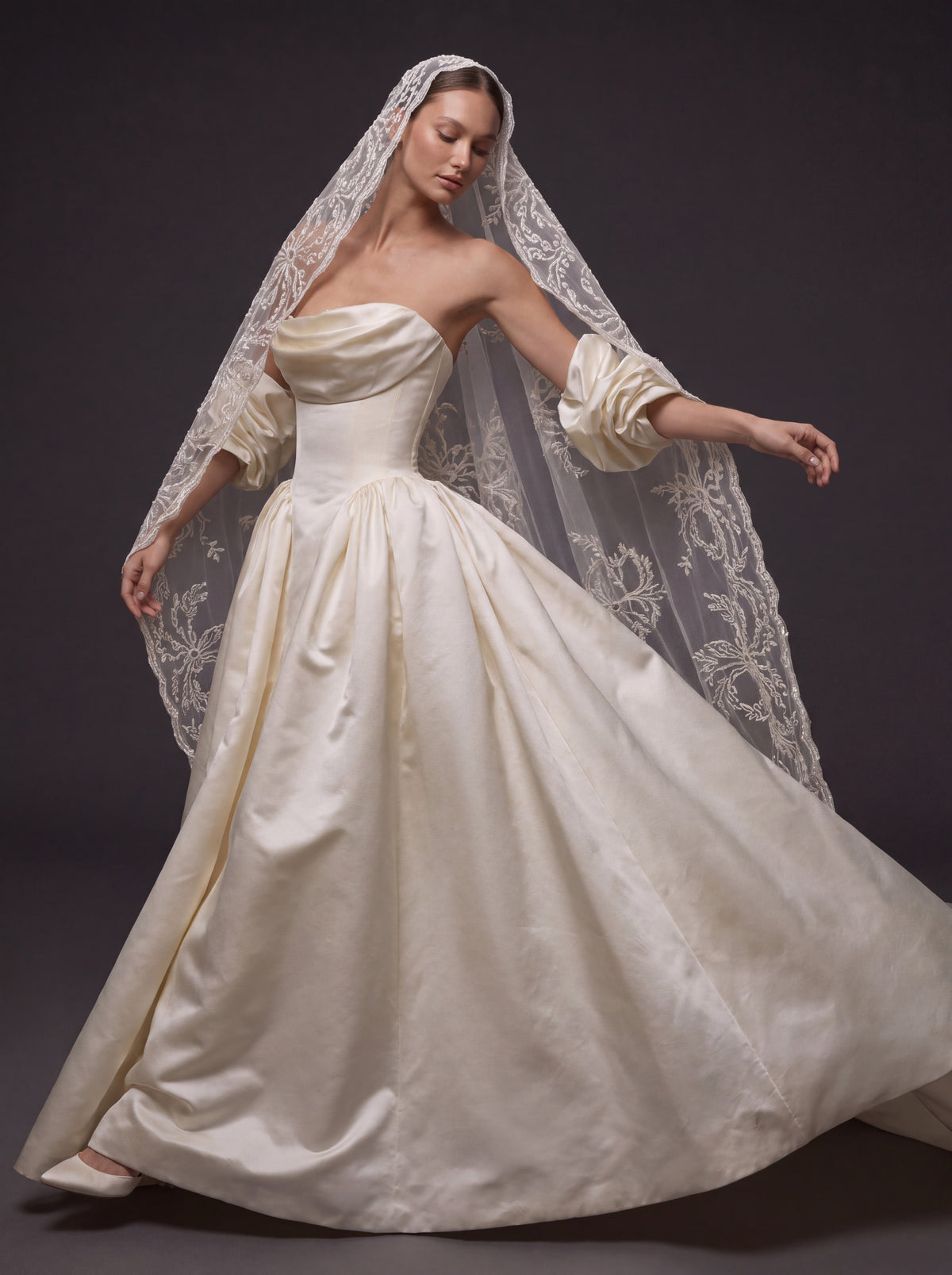 Pearl Ivory Satin Basque Waist Ball Gown Wedding Dress – Draped Strapless Neckline, Detachable Puff Sleeves & Embroidered Cathedral Veil