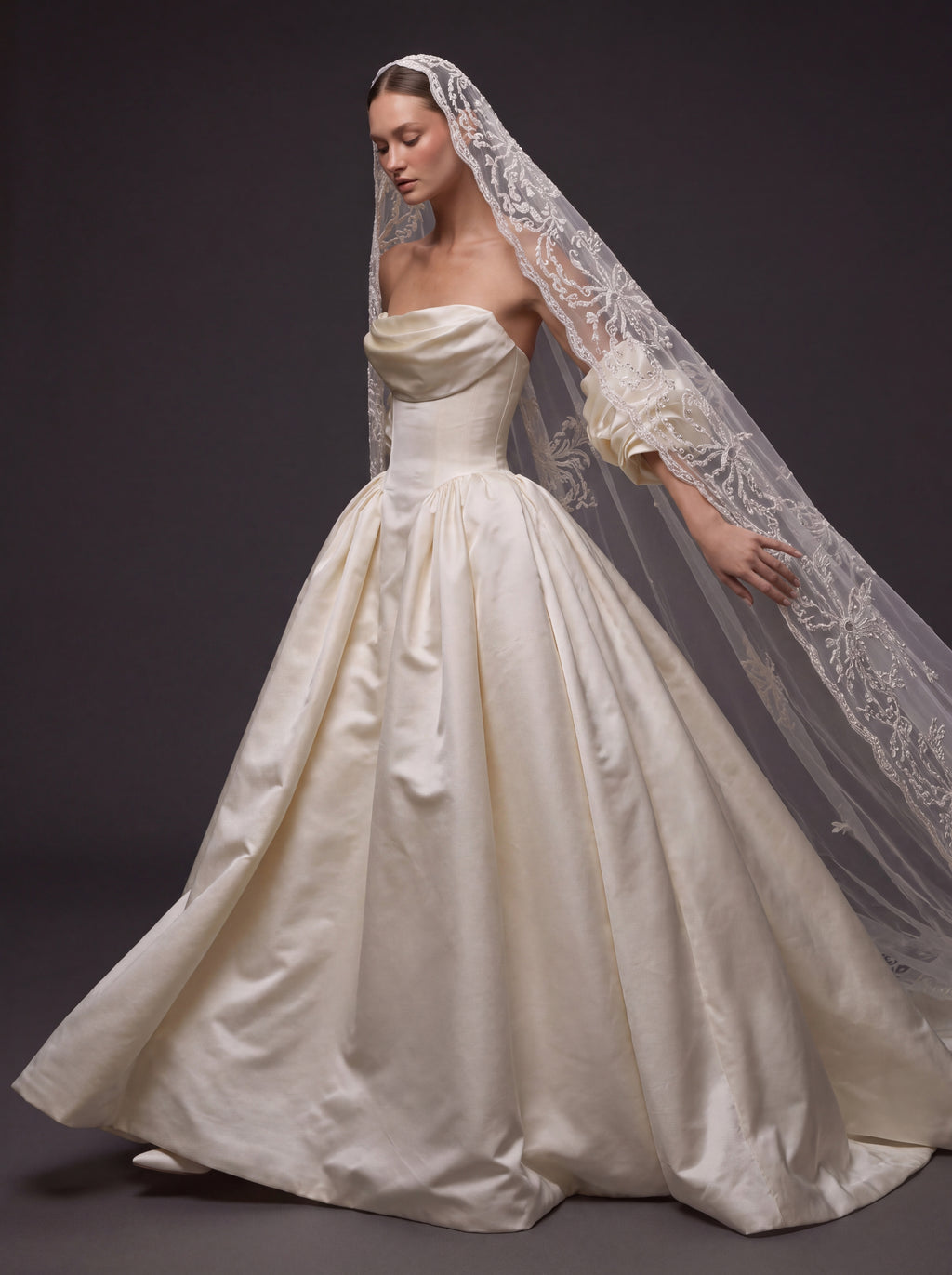 Pearl Ivory Satin Basque Waist Ball Gown Wedding Dress – Draped Strapless Neckline, Detachable Puff Sleeves & Embroidered Cathedral Veil
