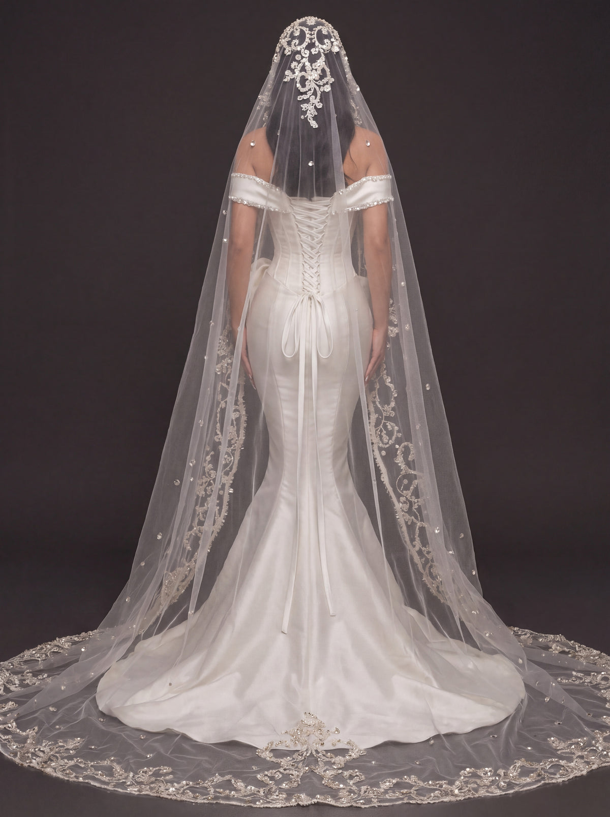 Pearl-Trimmed Satin Mermaid Wedding Dress – Off-Shoulder Draped Corset Gown with Sculpted Hip Detail & Floral Lace Cathedral Veil