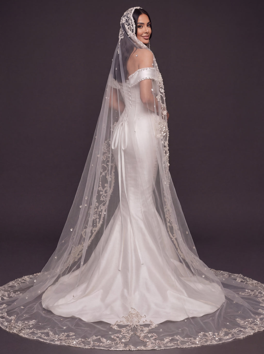 Pearl-Trimmed Satin Mermaid Wedding Dress – Off-Shoulder Draped Corset Gown with Sculpted Hip Detail & Floral Lace Cathedral Veil
