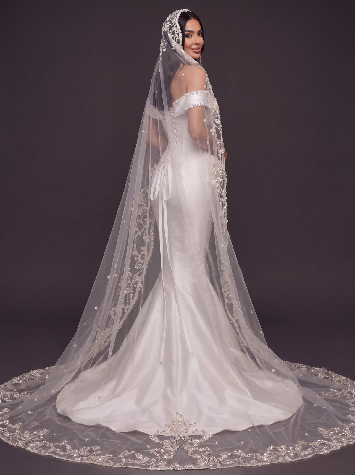 Pearl-Trimmed Satin Mermaid Wedding Dress – Off-Shoulder Draped Corset Gown with Sculpted Hip Detail & Floral Lace Cathedral Veil